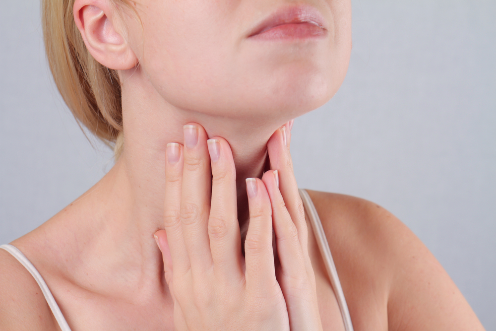 woman checking thyroid for problems